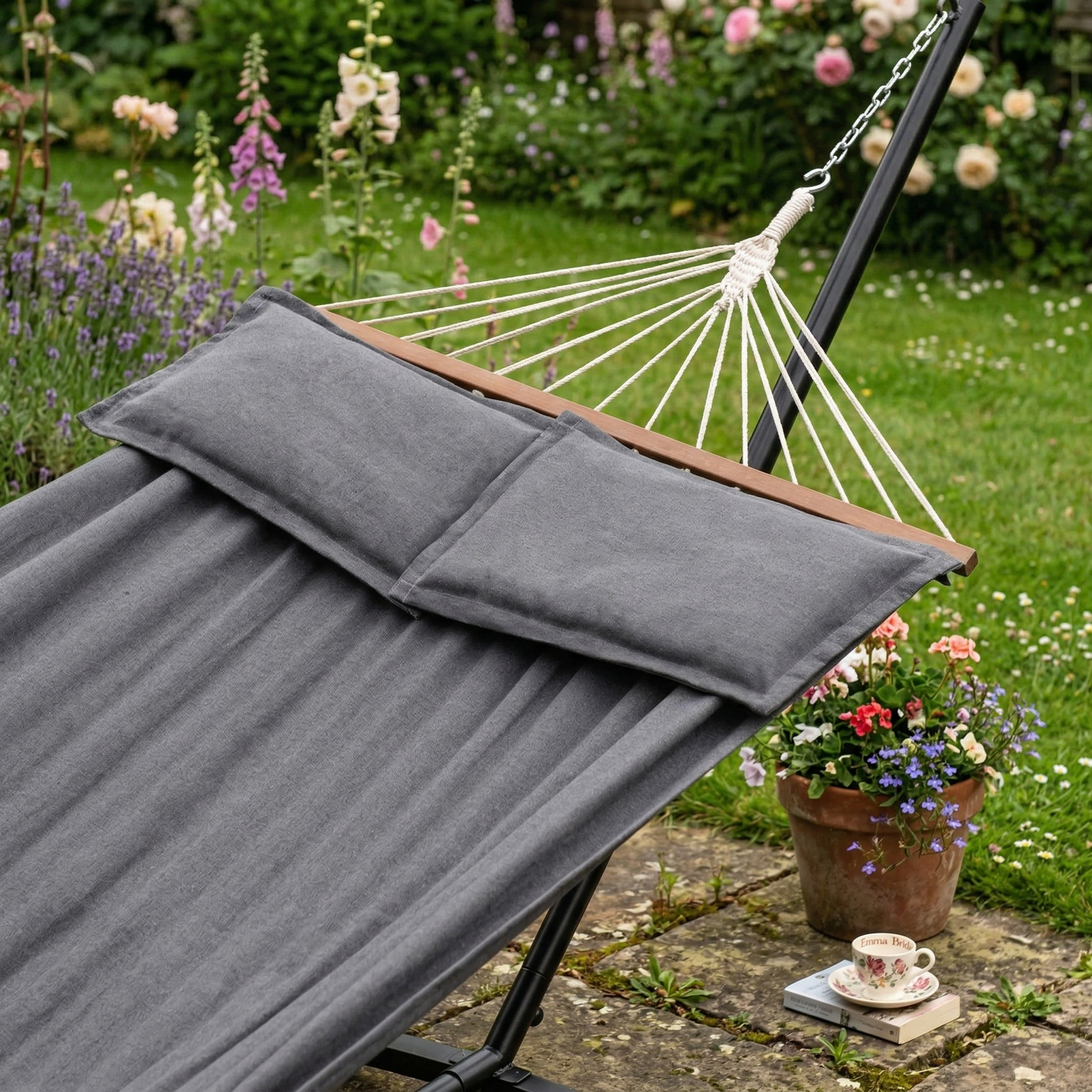Grey double hammock with cushions hanging in garden